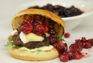 Grilled Australian lamb burger with brie, cranberry compote and roasted jalapeño aïoli