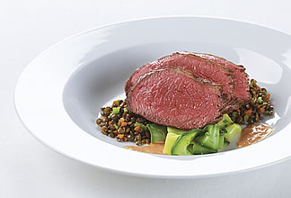 Charred sirloin cap steak served on zucchini ribbons and balsamic braised lentils