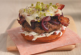 Grilled Australian lamb burger with red wine-braised onions, applewood-smoked bacon and swiss cheese topped with apple fennel yogurt remoulade