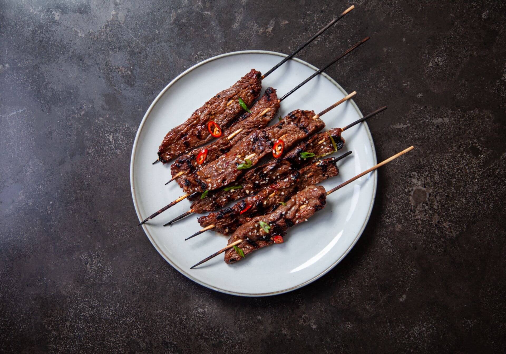 Gochujang minute steak skewers with charred broccolini and lime